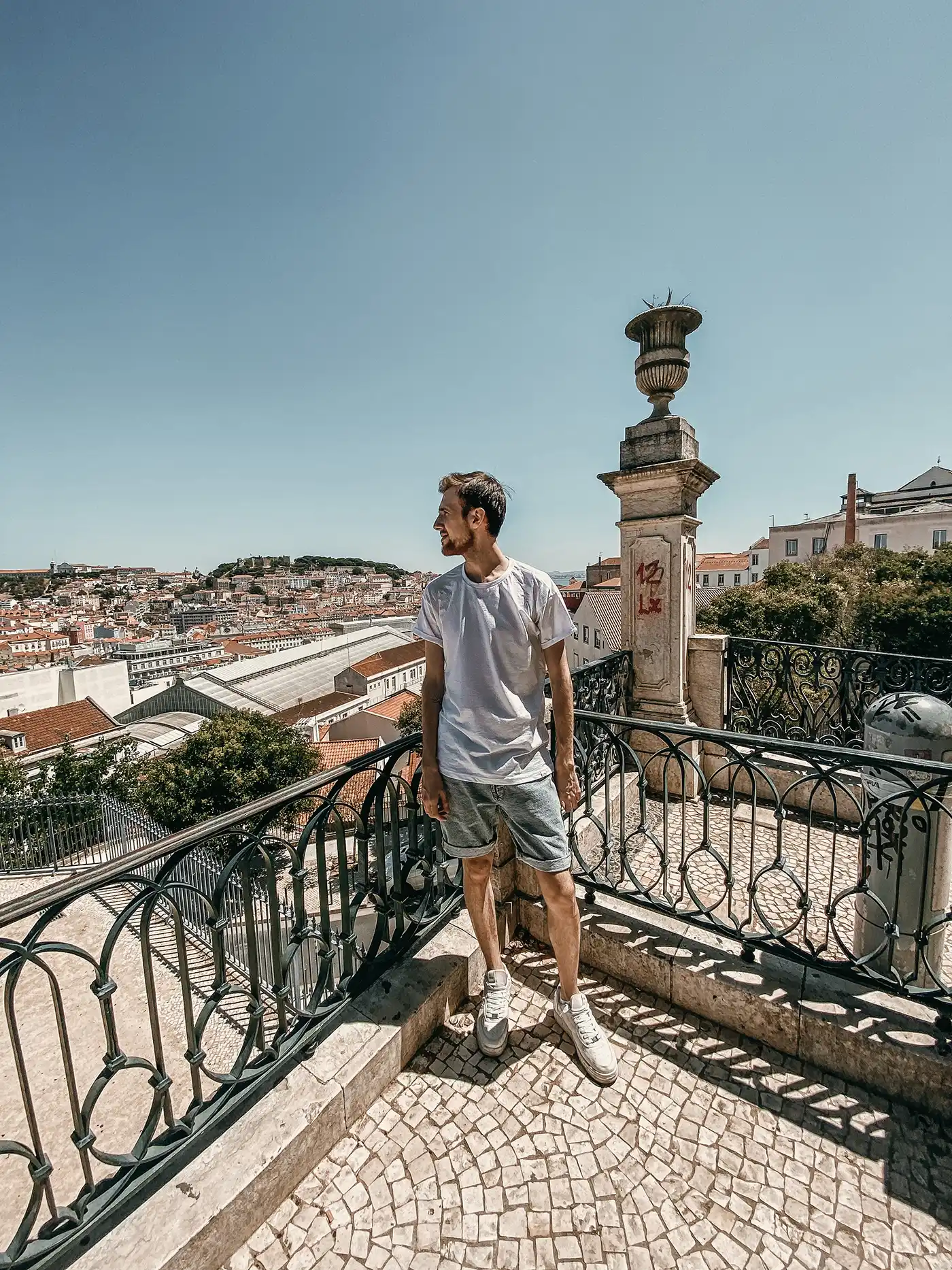 Roman standing on a balcony above a city